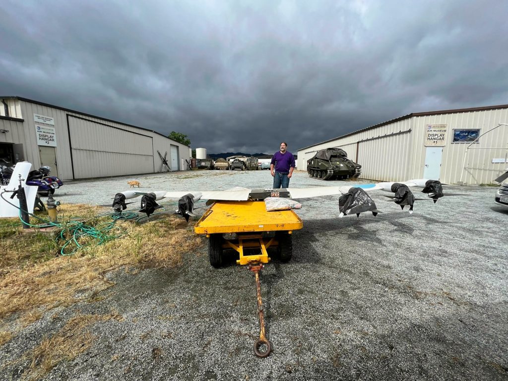 Chris standing behind the cart carrying the wings